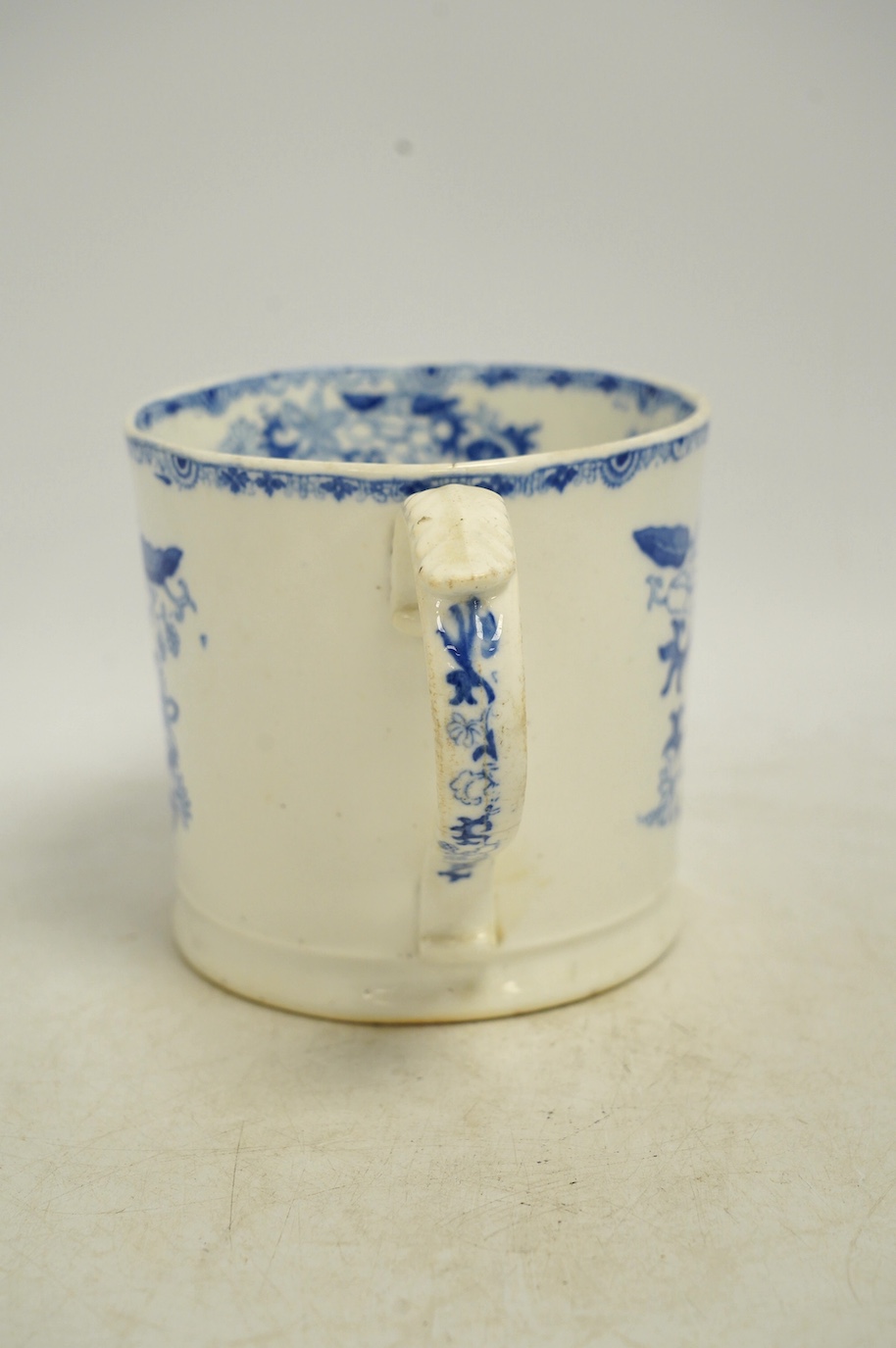 An early Victorian blue and white bone china mug, 13cm high. Condition - fair, crack to the handle